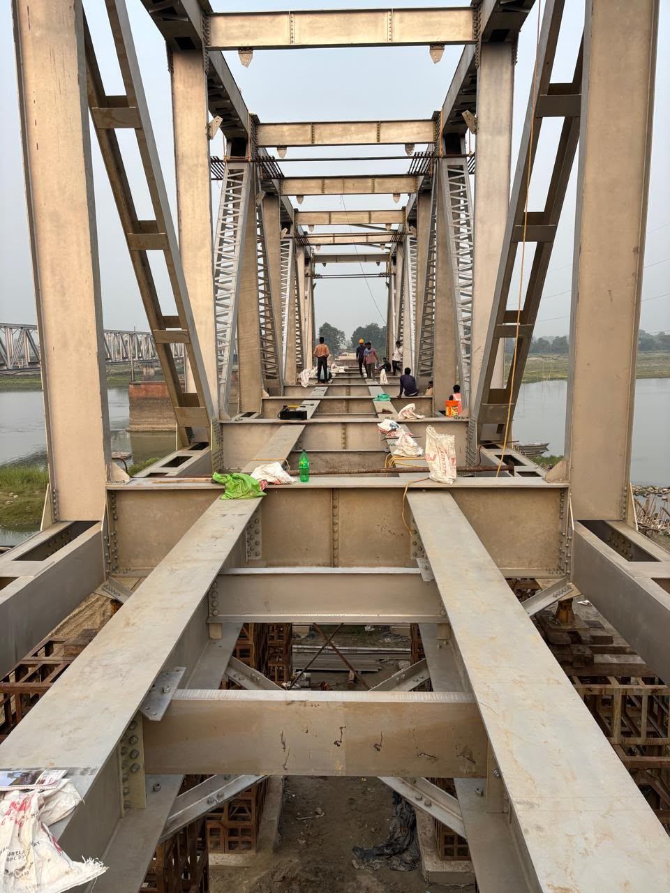 View through the length of a steel truss span under construction