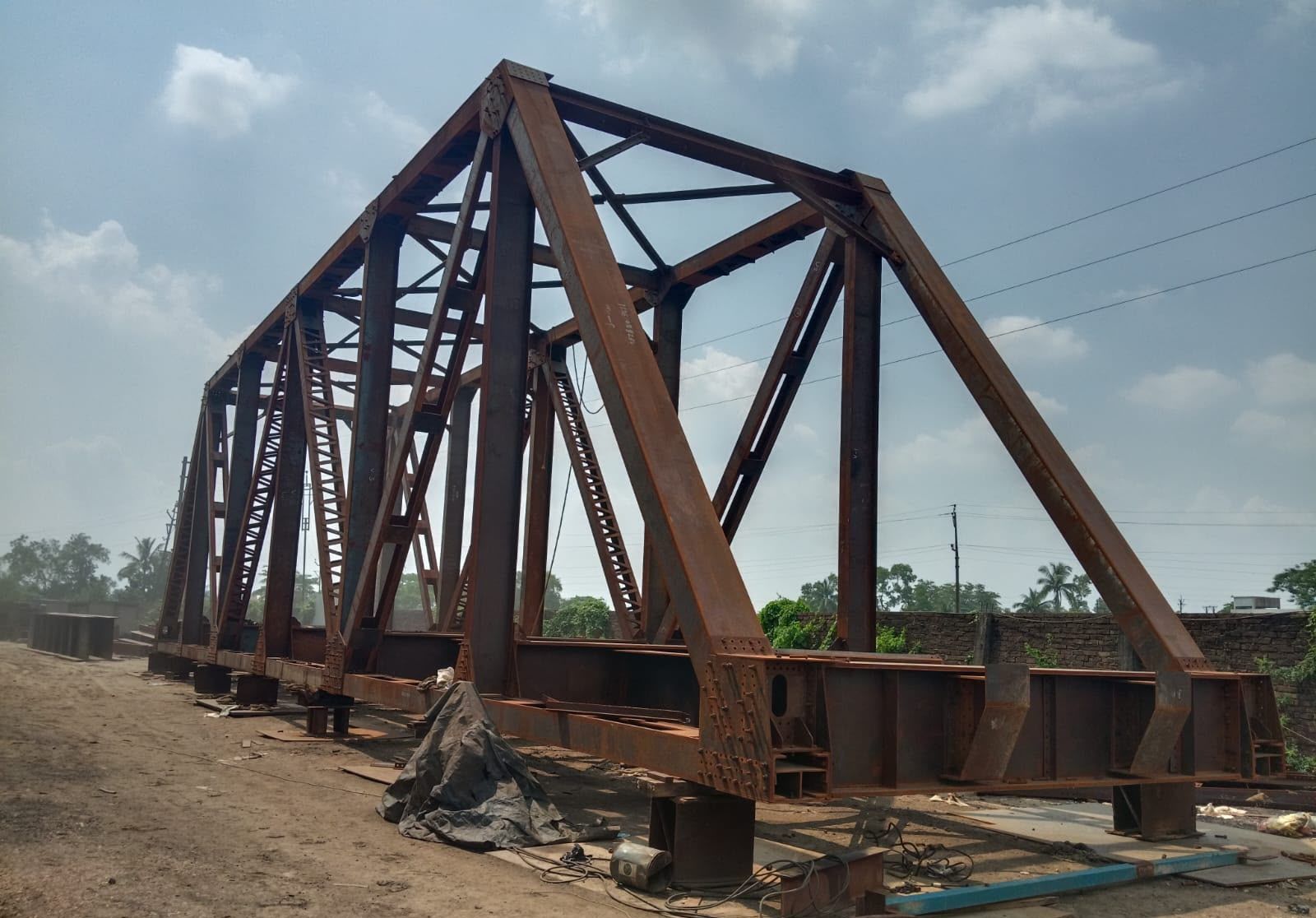 Unpainted steel through-truss girder assembled in the yard