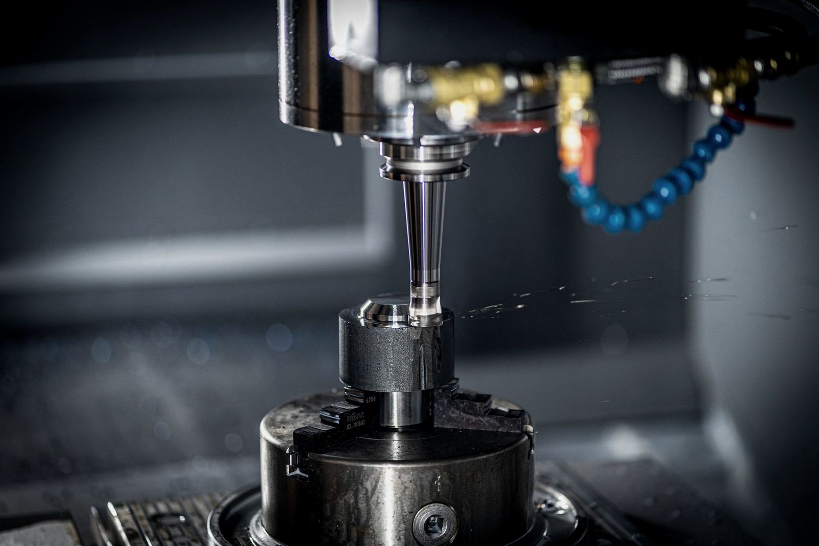 CNC machine spindle and tool above a clamped workpiece