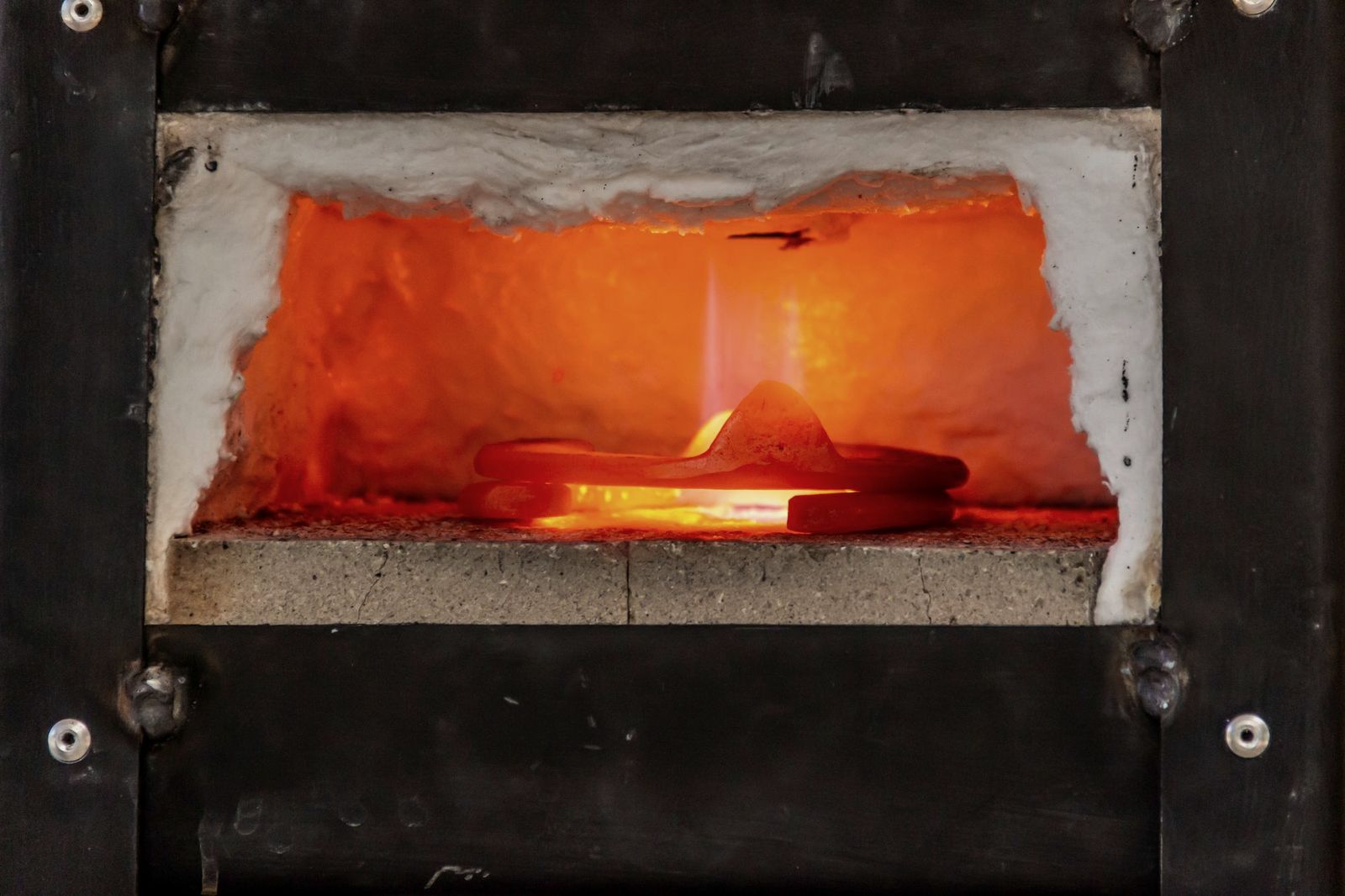 Steel glowing inside an electric heat treatment furnace