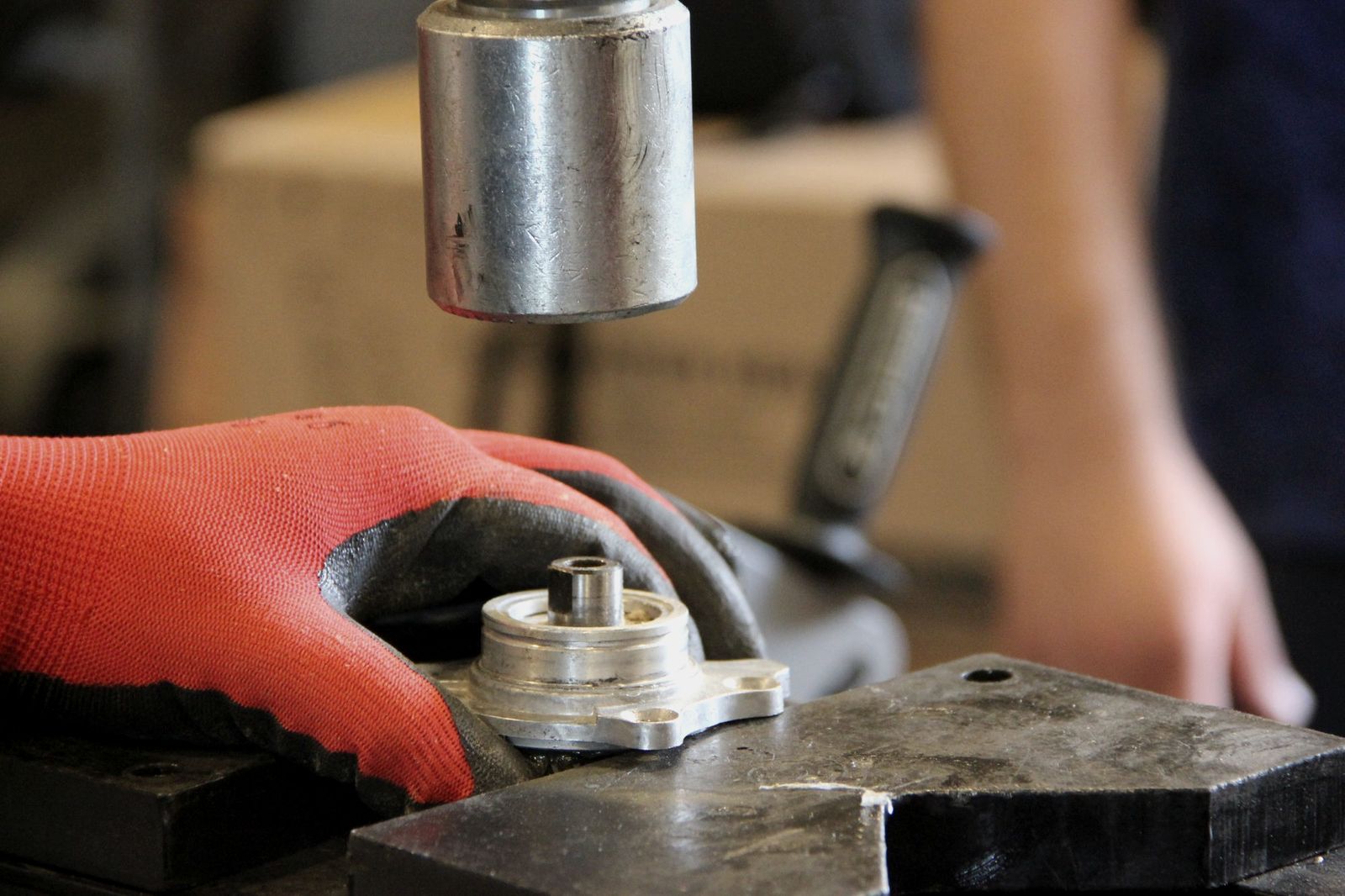 Inspector testing a machined steel part on a gauge